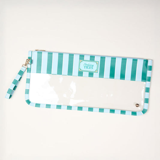 The Darling Effect Sicily Stripes Teal Mahjong Tile Keeper Pouch features blue and white vertical stripes, a clear front panel, a wrist strap, and a "Tiles" label on top. It is shown against a plain white background.