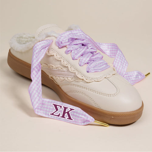 The Darling Effect's Sigma Kappa Step It Up Shoelaces feature light purple gingham with gold tips and the ΣΚ symbol, shown here on a cream sneaker with fluffy interior and beige lace trim—ideal for sorority gifts against a neutral backdrop.