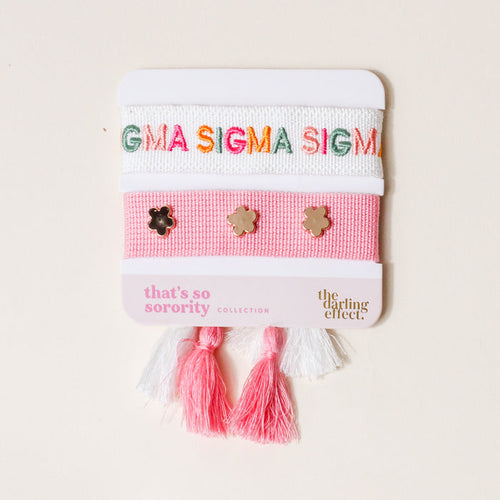 The Darling Effect's Sigma Sigma Sigma Woven Bracelet Set features a pink band with flower charms, colorful embroidery, and pink & white tassels—an ideal sisterhood accessory or sorority gift.