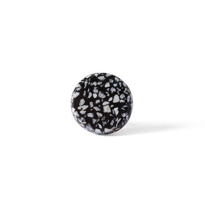 The Speckle Black and White Knob 4.4cm features a round shape with a terrazzo-inspired pattern, shown against a plain white background—an elegant accent for modern home decor.