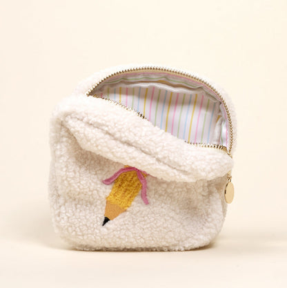The Darling Effect's Square Pencil Me In Teddy Pouch features a small, fluffy sherpa design with a yellow pencil motif, pink bow, and pastel striped lining—perfect for your accessory set or pairing with other teddy pouches.