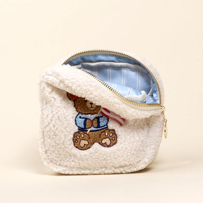 The Darling Effect's Square Star Spangled Bear Teddy Pouch is a fluffy sherpa pouch with teddy bear embroidery and a blue striped lining.
