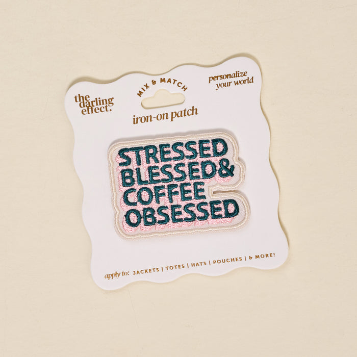 The Darling Effect's Stressed, Blessed, & Coffee Obsessed Mix & Match Iron-On Patch features pink and teal embroidery—perfect to customize your look. Packaged on a white card, it's part of a colorful collection.