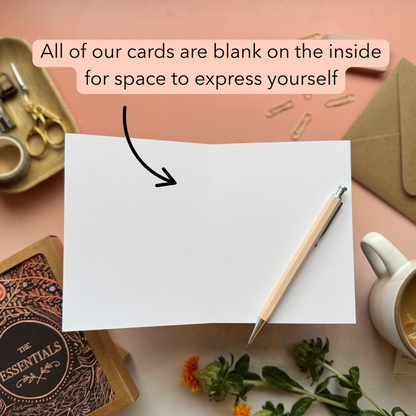 Blank card with pen and stationery items on a pink background