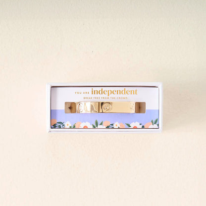 The Darling Effect's "You Are A Leader" gold cuff bracelet features engraved symbols and comes in a floral box with the message, "You are independent. Break free from the crowd," making it a meaningful gift to inspire individuality.