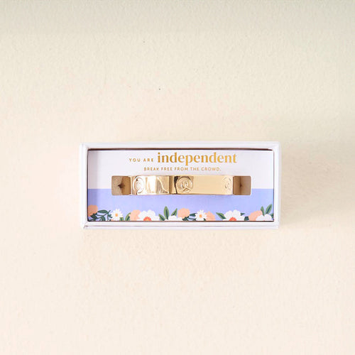 The Darling Effect's "You Are A Leader" gold cuff bracelet features engraved symbols and comes in a floral box with the message, "You are independent. Break free from the crowd," making it a meaningful gift to inspire individuality.
