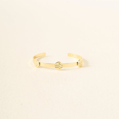 The Darling Effect’s You Are A Leader Skinny Stacker Trait Bracelet is a 14k gold plated adjustable cuff with three engraved designs, including shaking hands in the center, shown on an off-white background—ideal for gifting.