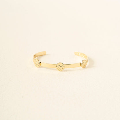 The Darling Effect’s You Are Adventurous Skinny Stacker Bracelet is a 14k gold-plated adjustable cuff with three round zigzag-engraved accents, shown on a simple light background.