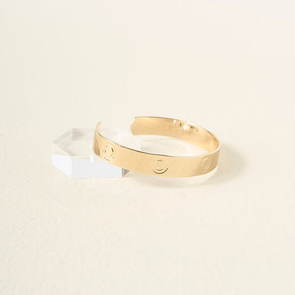 The Darling Effect’s You Are Bold Cuff Bracelet, crafted in sterling silver with engraved circular patterns, is showcased on a faceted clear block against a soft background—an ideal choice for a meaningful gift.