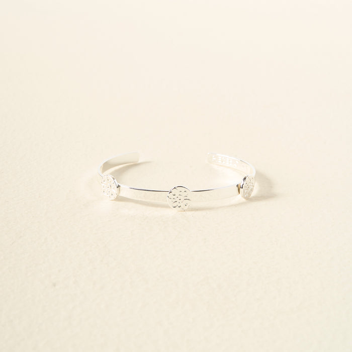 The Darling Effect's You Are Compassionate Skinny Stacker Bracelet is an adjustable silver cuff with three round, detailed discs, shown on a light cream background.