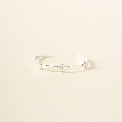 The Darling Effect's You Are Compassionate Skinny Stacker Bracelet is an adjustable silver cuff with three round, detailed discs, shown on a light cream background.