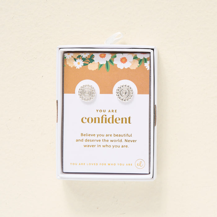 The Darling Effect’s You Are Confident Dainty Stud Earrings come boxed with a floral card reading, “Believe you are beautiful and deserve the world. Never waver in who you are.” Perfect for gifting.