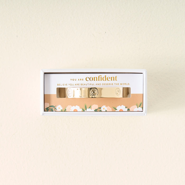 The Darling Effect’s "You Are Confident Trait Cuff Bracelet" comes in a white floral box with the message “You are confident. Believe you are beautiful and deserve the world”—a thoughtful gift for someone special.