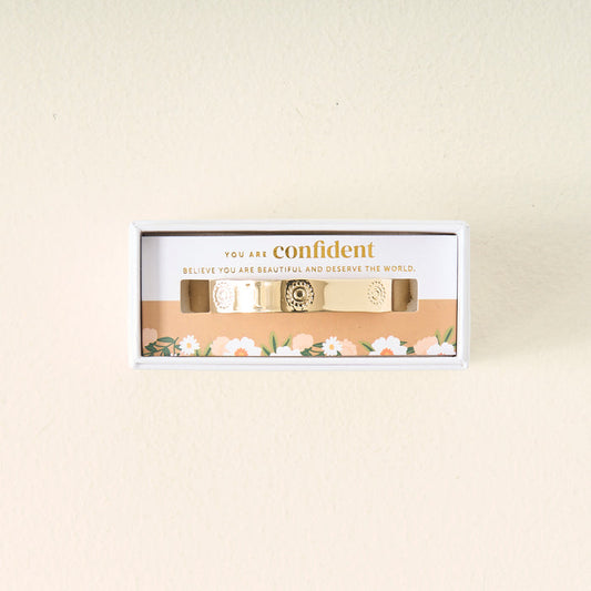 The Darling Effect’s "You Are Confident Trait Cuff Bracelet" comes in a white floral box with the message “You are confident. Believe you are beautiful and deserve the world”—a thoughtful gift for someone special.