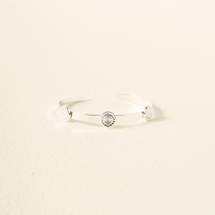 The Darling Effect You Are Creative Skinny Stacker Bracelet—a silver adjustable cuff with three round engravings, shown on a light textured surface—makes the perfect gift-ready jewelry for any occasion.