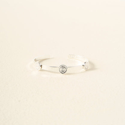 The Darling Effect You Are Creative Skinny Stacker Bracelet—a silver adjustable cuff with three round engravings, shown on a light textured surface—makes the perfect gift-ready jewelry for any occasion.