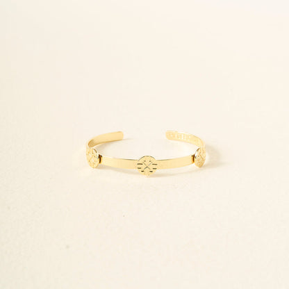 The Darling Effect’s You Are Driven Skinny Stacker Bracelet is a 14k gold plated adjustable cuff with three engraved circular symbols, shown on an off-white background—ideal as a gift-ready jewelry piece.