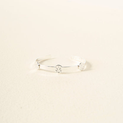 The Darling Effect’s You Are Friendly Skinny Stacker Bracelet is a delicate, adjustable silver cuff with three circular cutouts—displayed on a light, textured surface and perfect as gift-ready jewelry for any occasion.