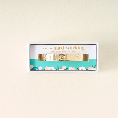 The Darling Effect's "You Are Hard-Working Cuff Bracelet" comes in a white floral box with a card that reads: You are hard-working. Keep on making it happen—a thoughtful gift for someone special.
