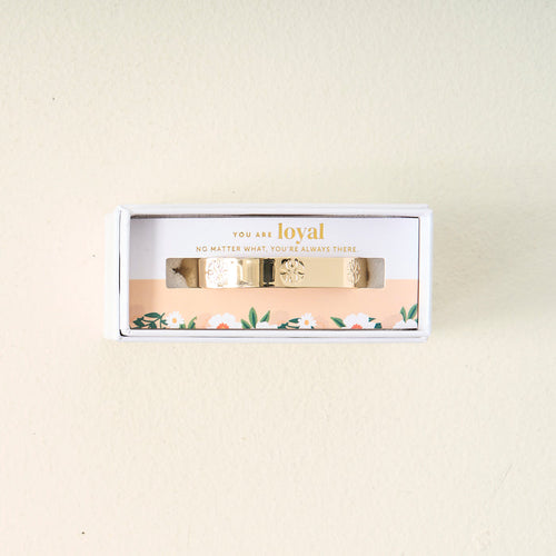 The Darling Effect’s You Are Loyal Cuff Bracelet features floral designs and comes in a white box with “You are loyal. No matter what, you’re always there.” The packaging is accented with a pretty floral motif at the bottom.