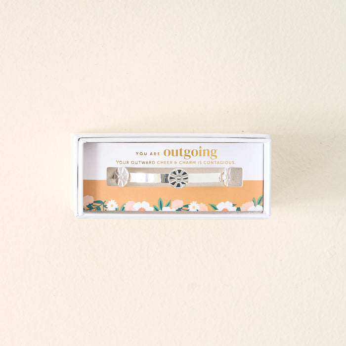 The Darling Effect's You Are Outgoing Skinny Stacker Bracelet is a 14k gold plated adjustable cuff with a central charm and two side charms, gift-ready in a box that says, "You are outgoing. Your outward cheer & charm is contagious.