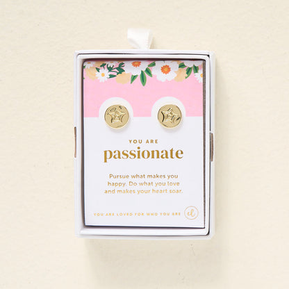 The Darling Effect You Are Passionate Dainty Stud Earrings are gold plated studs in a floral gift box. The card inside says, "You are passionate. Pursue what makes you happy. Do what you love and makes your heart soar.