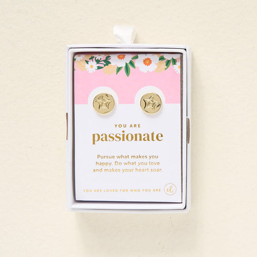 The Darling Effect You Are Passionate Dainty Stud Earrings are gold plated studs in a floral gift box. The card inside says, "You are passionate. Pursue what makes you happy. Do what you love and makes your heart soar.
