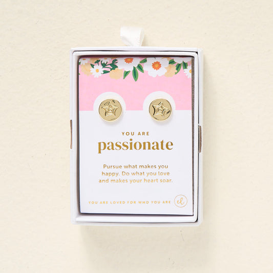 The Darling Effect You Are Passionate Dainty Stud Earrings are gold plated studs in a floral gift box. The card inside says, "You are passionate. Pursue what makes you happy. Do what you love and makes your heart soar.