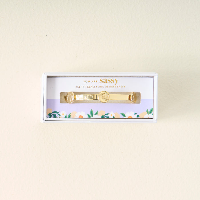 The Darling Effect You Are Sassy Skinny Stacker Bracelet comes in a white box with floral designs and the phrase "You are Sassy. Keep it classy and always sassy"—a gift-ready jewelry piece for any special occasion.