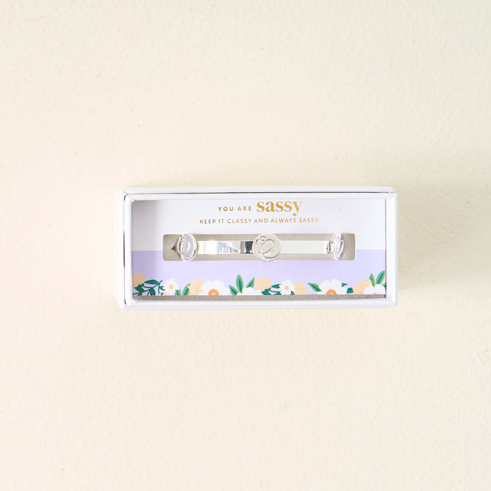 The Darling Effect’s You Are Sassy Skinny Stacker Bracelet comes in a white floral gift box with "You are sassy. Keep it classy and always sassy" printed on it.