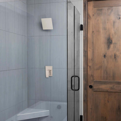 Bathroom with gray tiled wall, shower area with ZLINE 12 in. Oversized Bliss Shower Head in Brushed Nickel (BLS-H12-BN), and a wooden door.