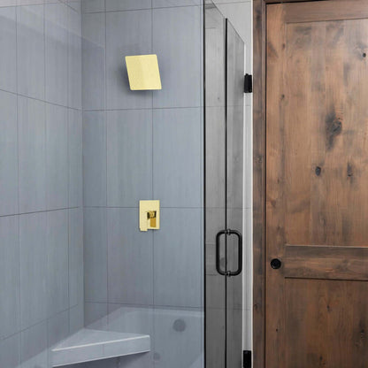ZLINE 12 in. Oversized Bliss Shower Head in Polished Gold (BLS-H12-PG) in a glass shower enclosure, wooden door, and tiled walls.